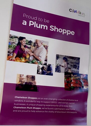 White sign with purple shapes that reads Proud to be a Plum Shoppe, which indicates Coconut Whisk is a Female BIPOC owned business