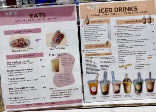 A pink menu with options to order mini pancakes and waffle sticks, and a peach menu with vegan boba tea choices at Coconut Whisk Cafe in Minneapolis Minnesota